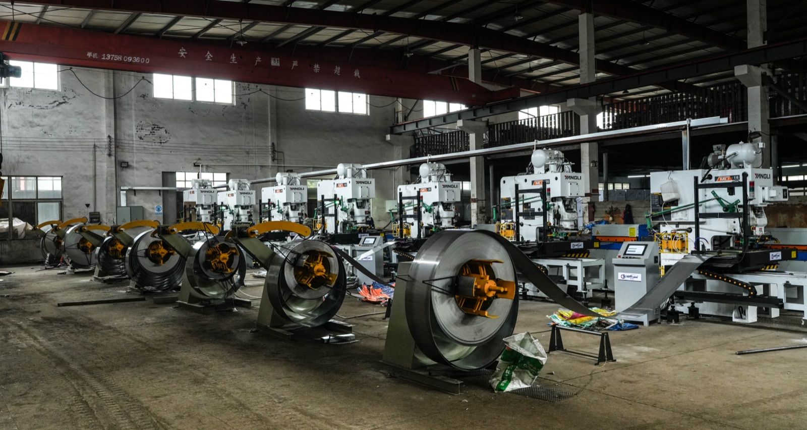Stainless steel coils on decoilers feeding the washer presses