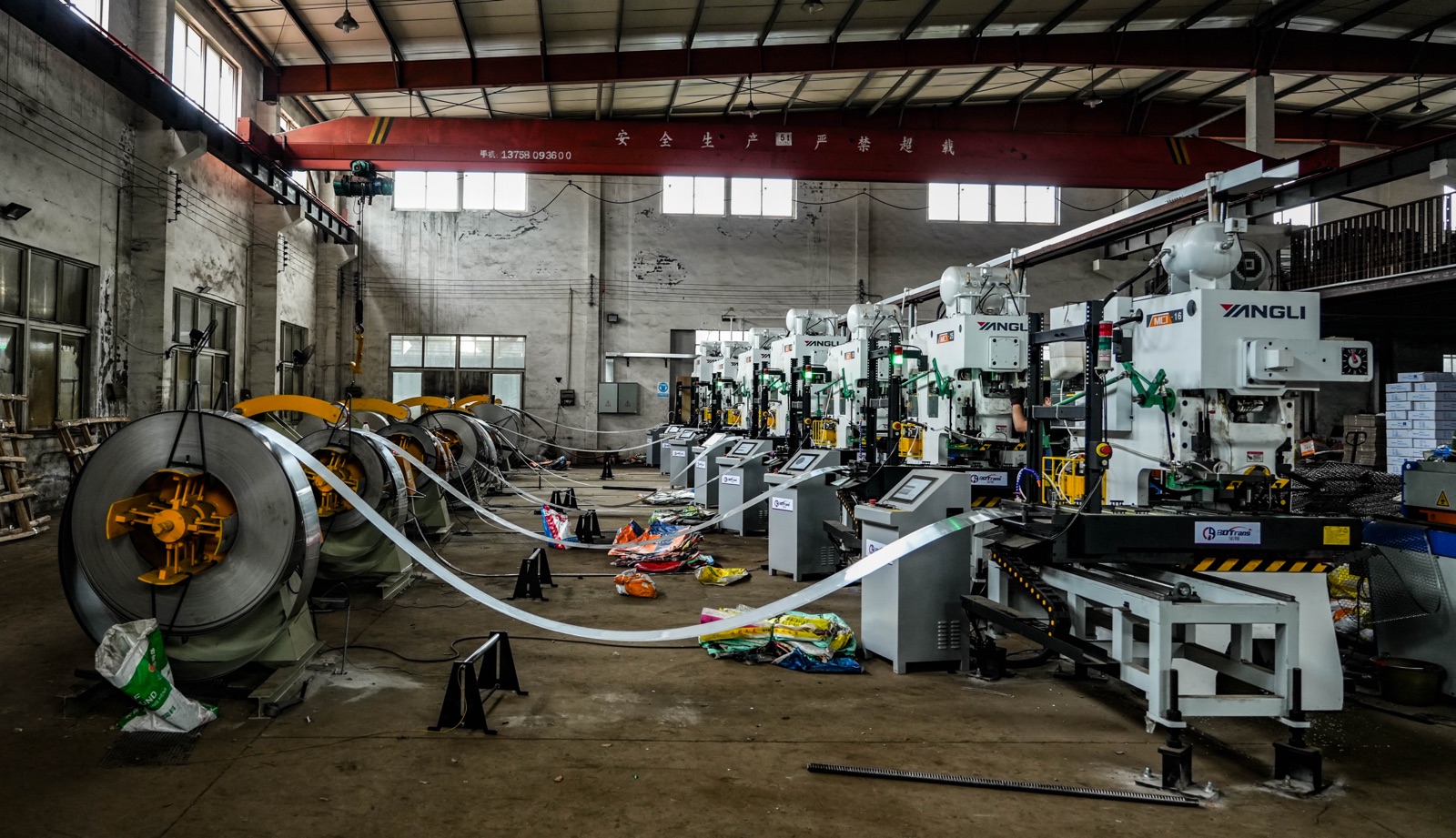 HUIHUI stainless steel washer workshop — coil feeders supplying a row of precision stamping presses