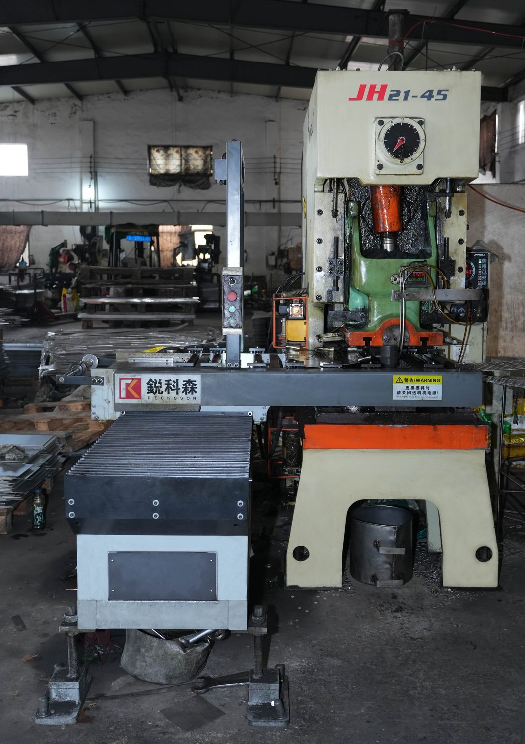 JH21 power press with automatic stainless coil feeder running fender washer blanks